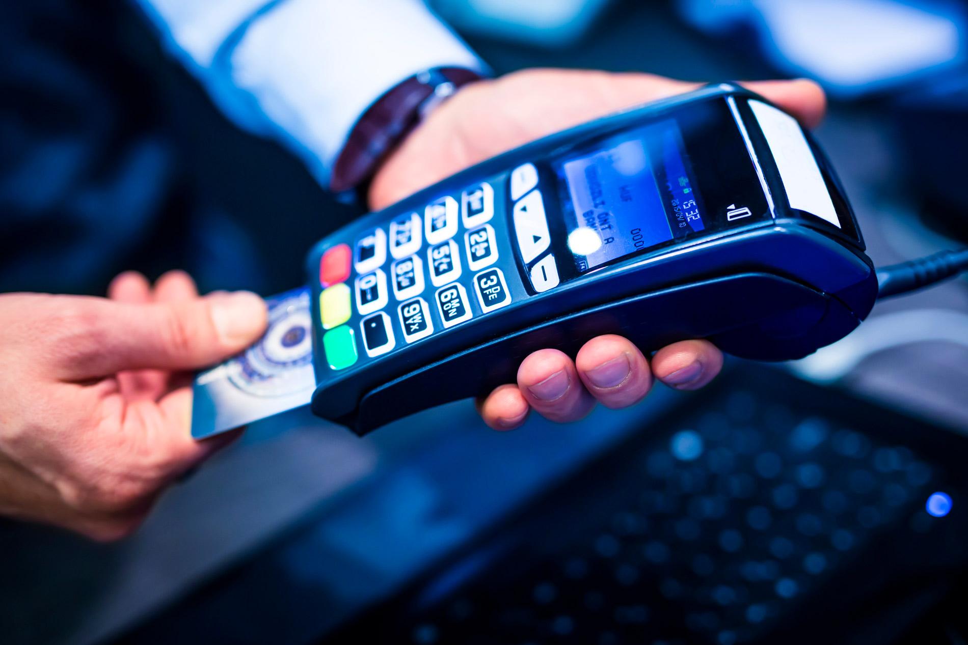 Modern payment terminal displaying an approved credit card transaction