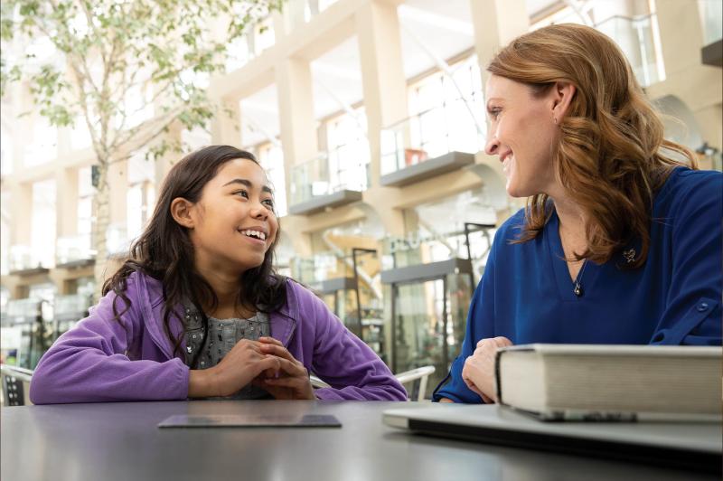 A CASA volunteer talking to a young girl